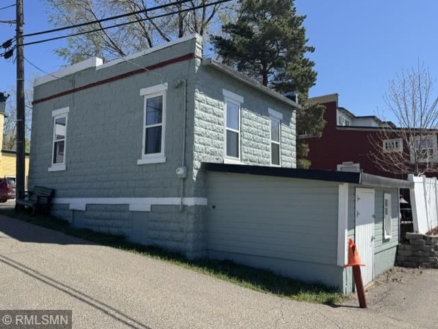 Right side (alley side) of building showing basement entrance.