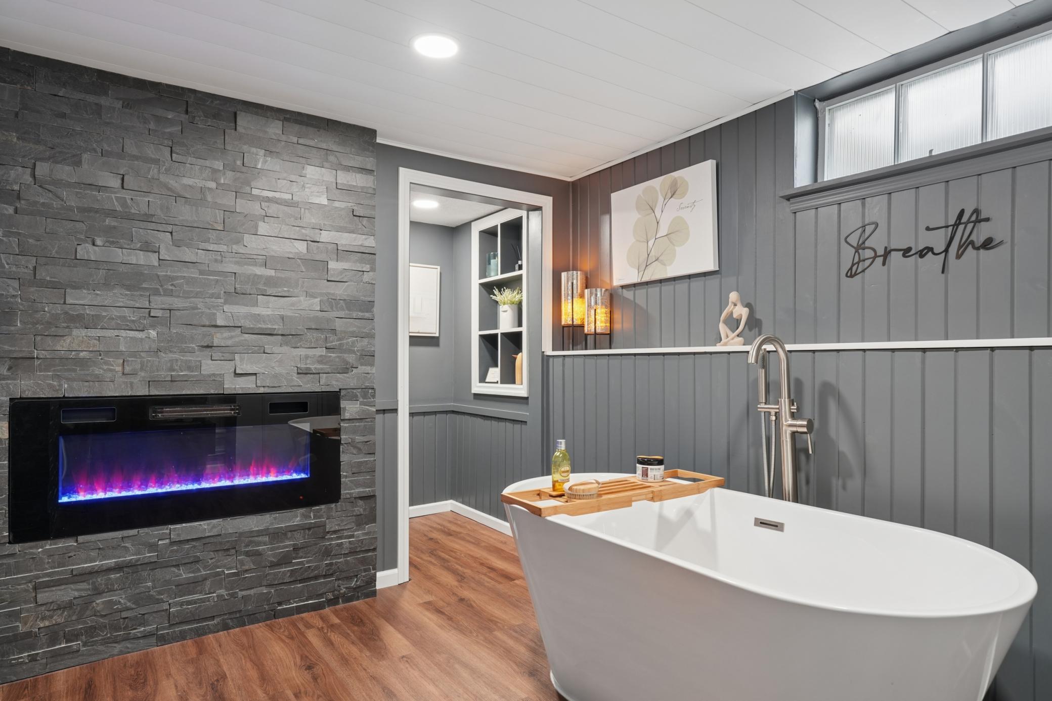 Lower level 3/4 bath with an electric fireplace.