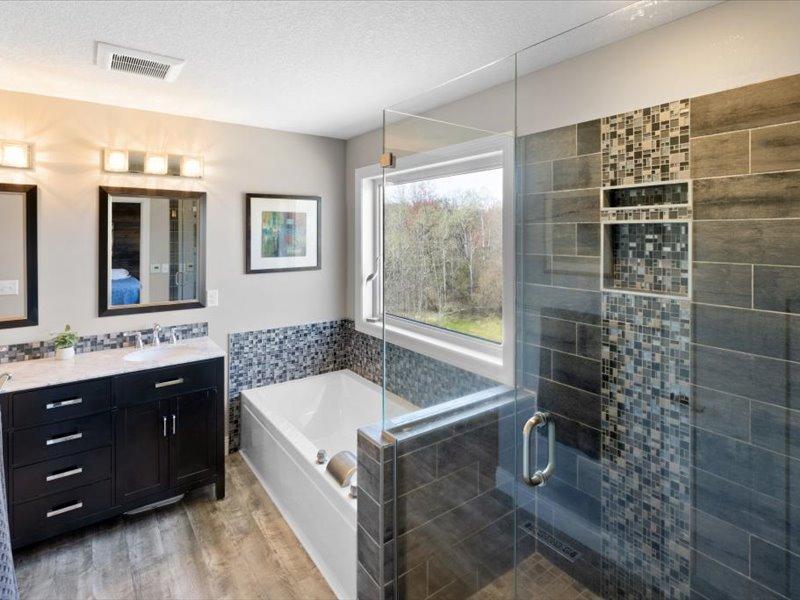 Primary Bath with Beautifully tiled glass shower