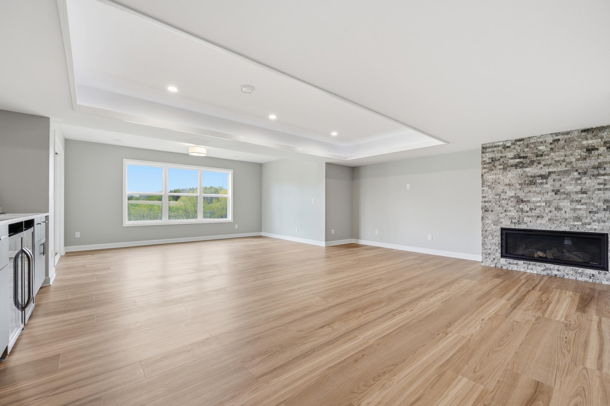Beautiful recently finished basement with wet-bar, cove ceilings with lighting, and stone electric fireplace surround. Enjoy the wetland views.