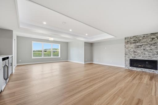 Beautiful recently finished basement with wet-bar, cove ceilings with lighting, and stone electric fireplace surround. Enjoy the wetland views.