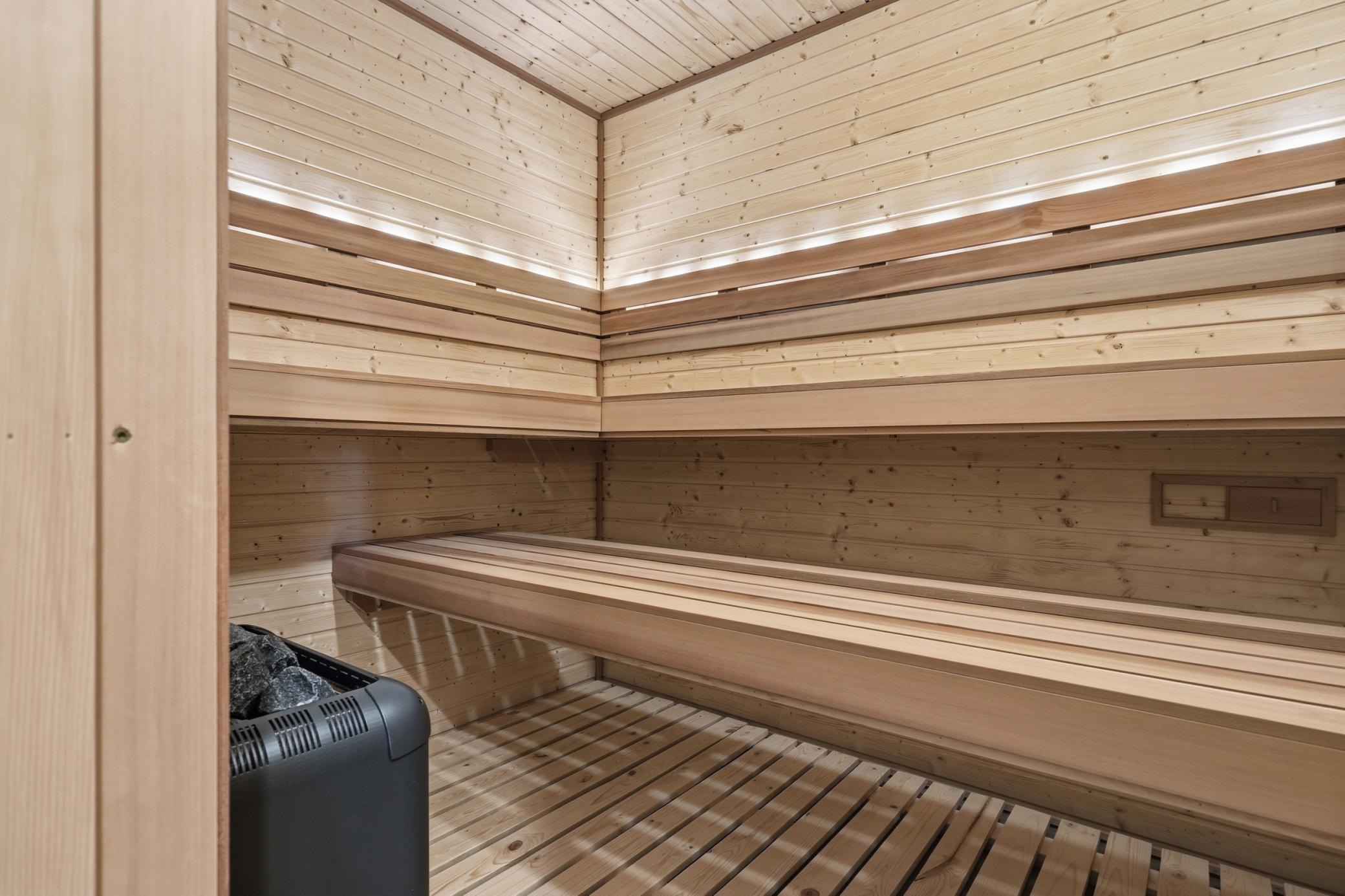 New, custom 7x8 sauna with dimmable light and programmable color changing light features in the backrest.