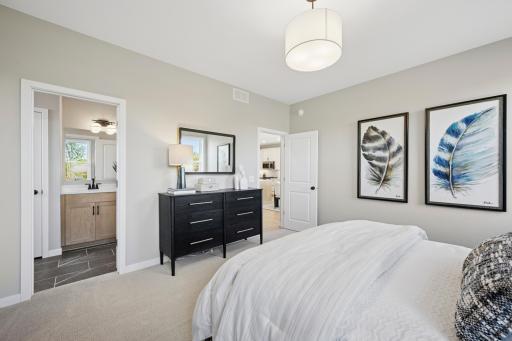Main Floor Primary Suite with walkin closet, separate vanities and large tiled shower
