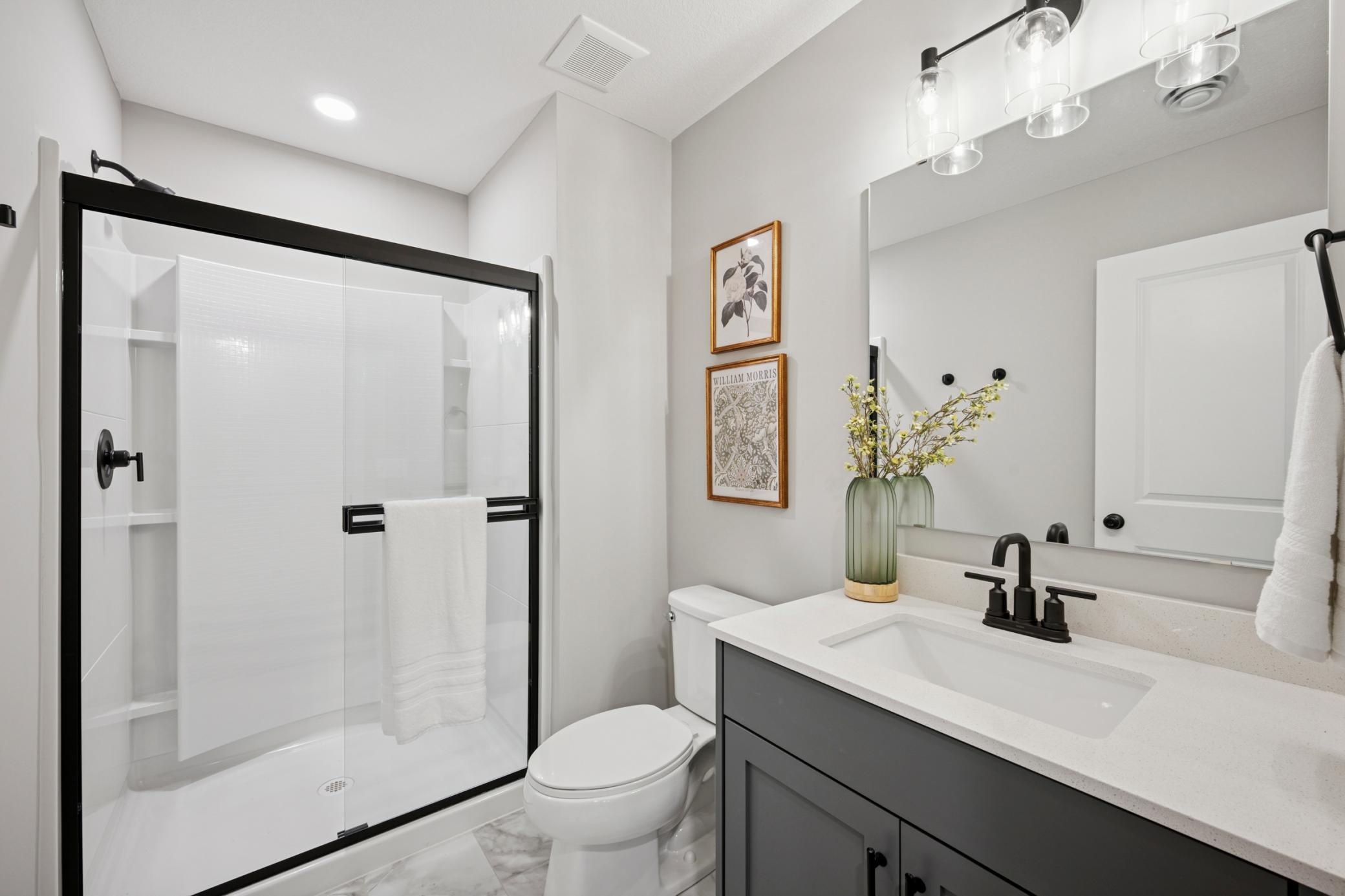 Spacious sun-filled finished Lower level with large mechanical room and additional large storage room! And 4th bedroom and another bathroom!