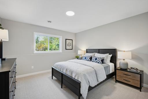 Spacious sun-filled finished Lower level with large mechanical room and additional large storage room! And 4th bedroom and another bathroom!