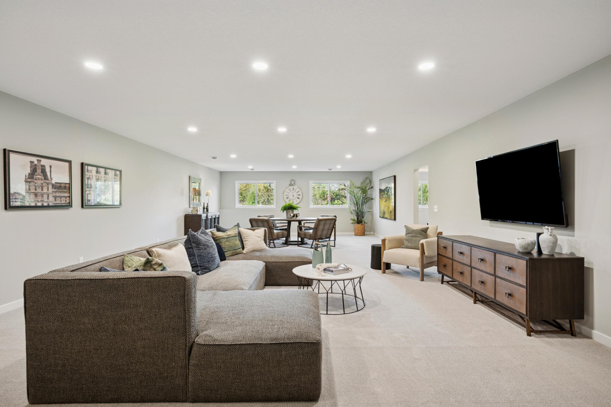 Spacious sun-filled finished Lower level with large mechanical room and additional large storage room! And 4th bedroom and another bathroom!