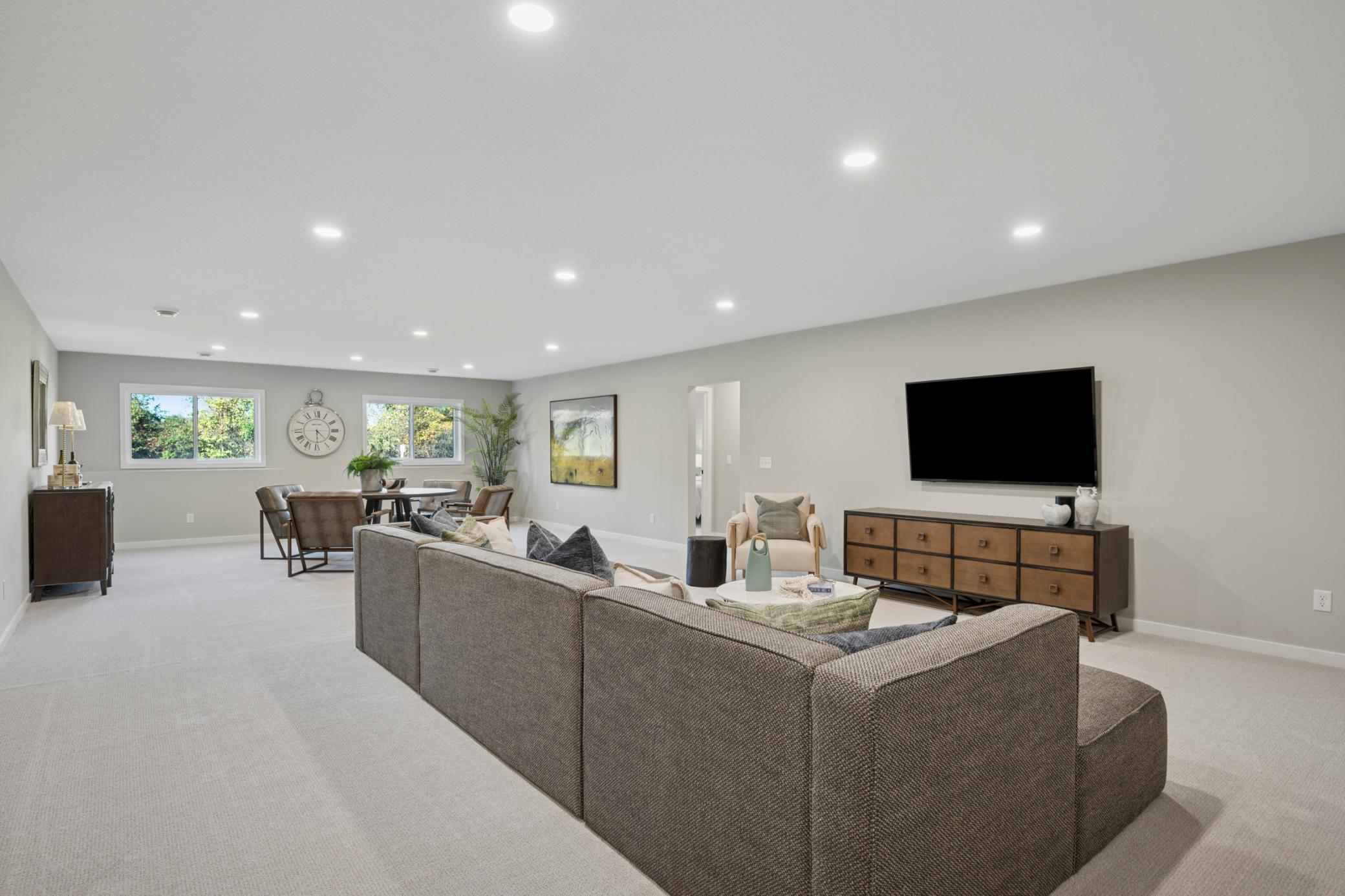 Spacious sun-filled finished Lower level with large mechanical room and additional large storage room! And 4th bedroom and another bathroom!