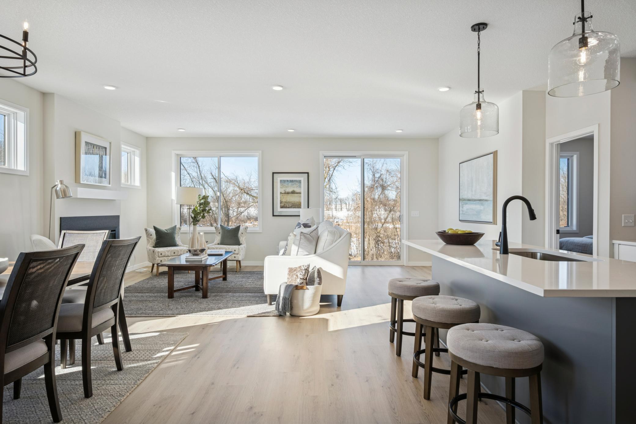 Sun-filled new Home with warranties, amazing views backing to wetlands!! 2 bedrooms on main floor, + flex room, and another bedroom at sunny finished lower level + storage room! And Spacious 3-car garage you will love!