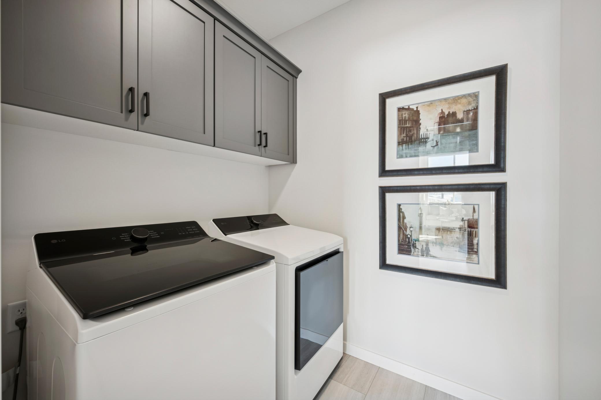 Convenient main floor laundry room with door, custom Cabinetry, and Washer & Dryer included!