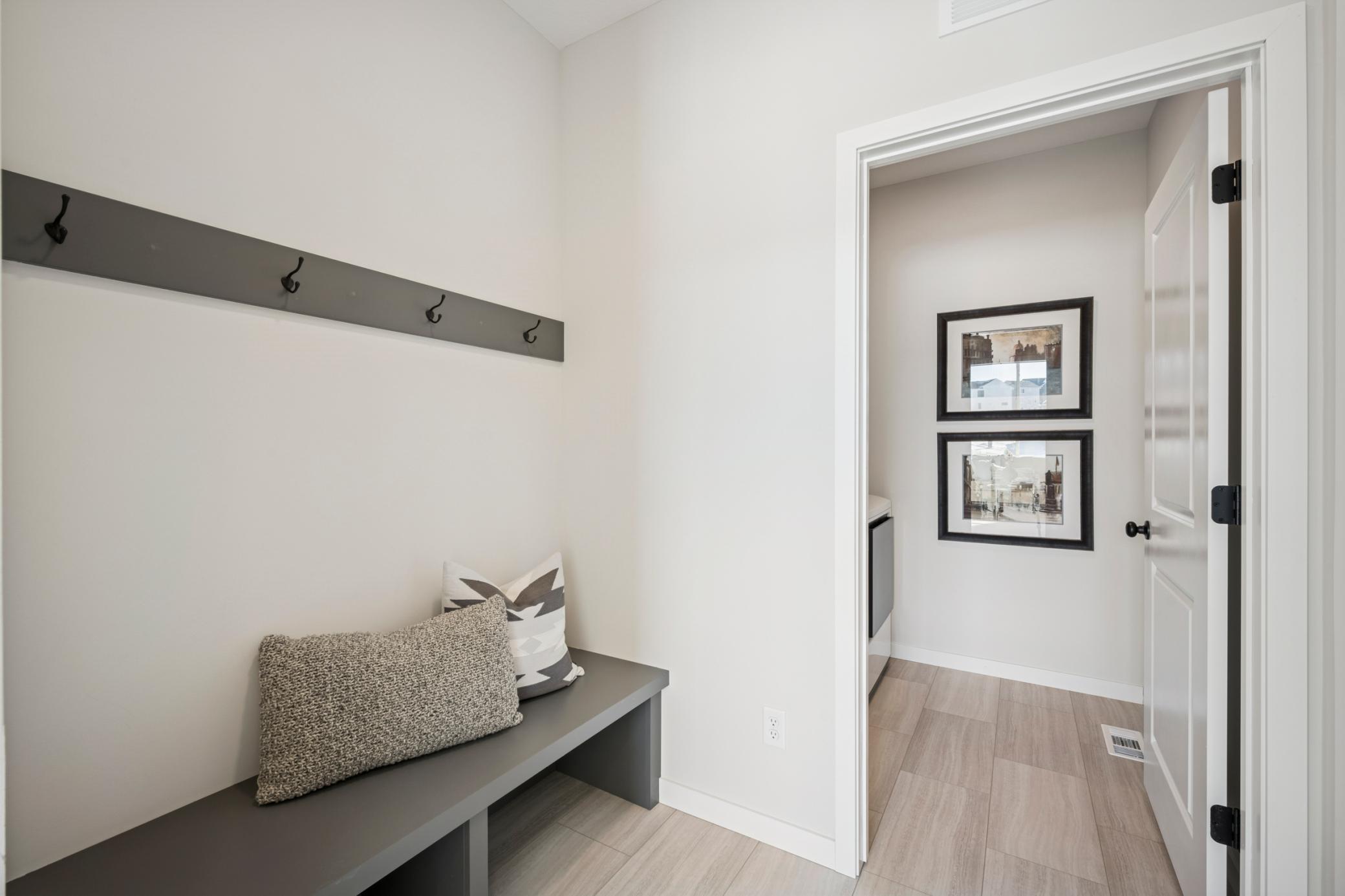 Spacious mudroom with built-in bench and separate Laundry room