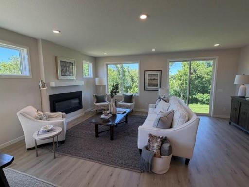 Sun-filled new Home with warranties, amazing views backing to wetlands!! 2 bedrooms on main floor, + flex room, and another bedroom at sunny finished lower level + storage room! And Spacious 3-car garage you will love!