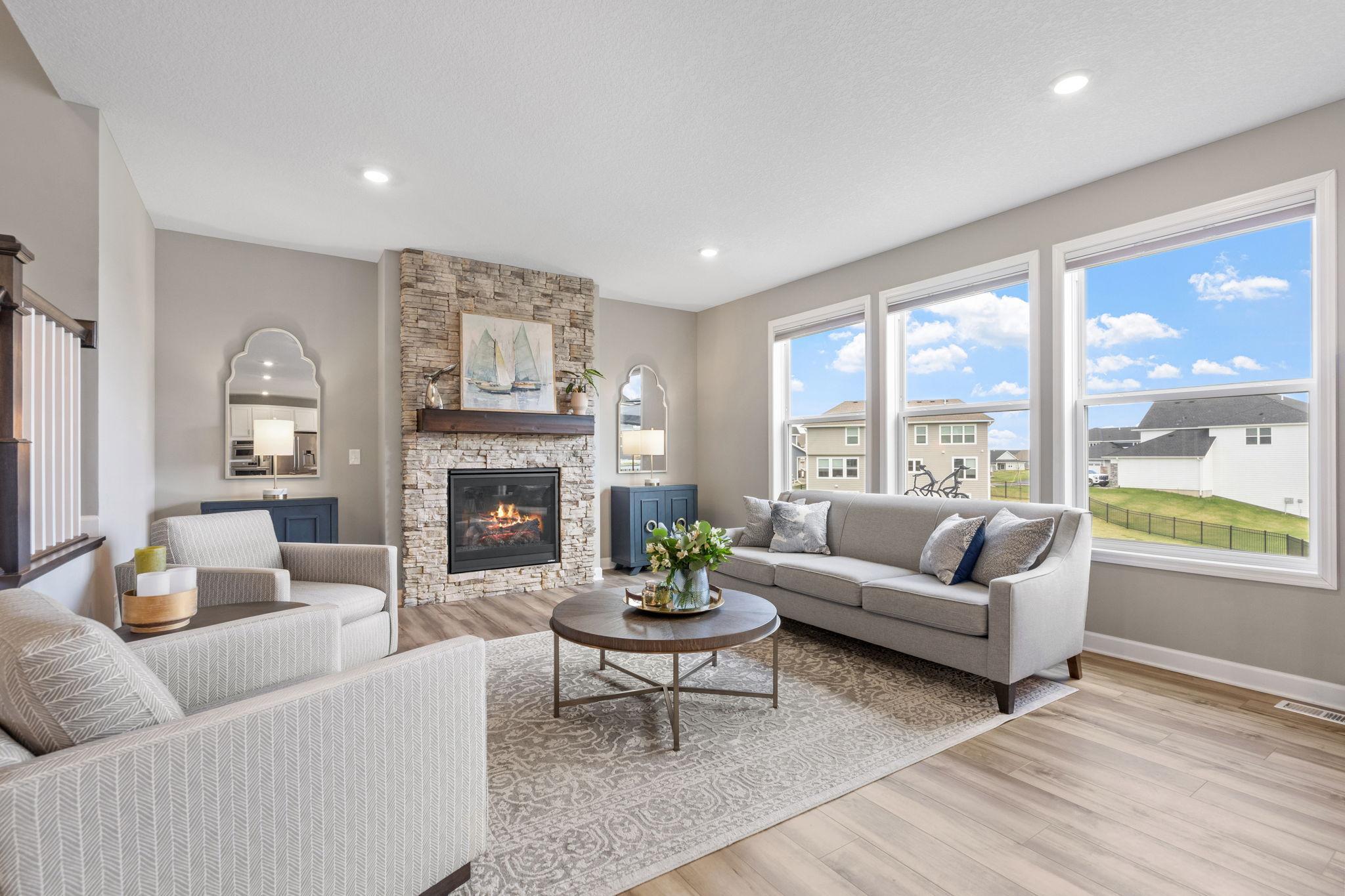 Gorgeous oversized windows with stone/gas fireplace