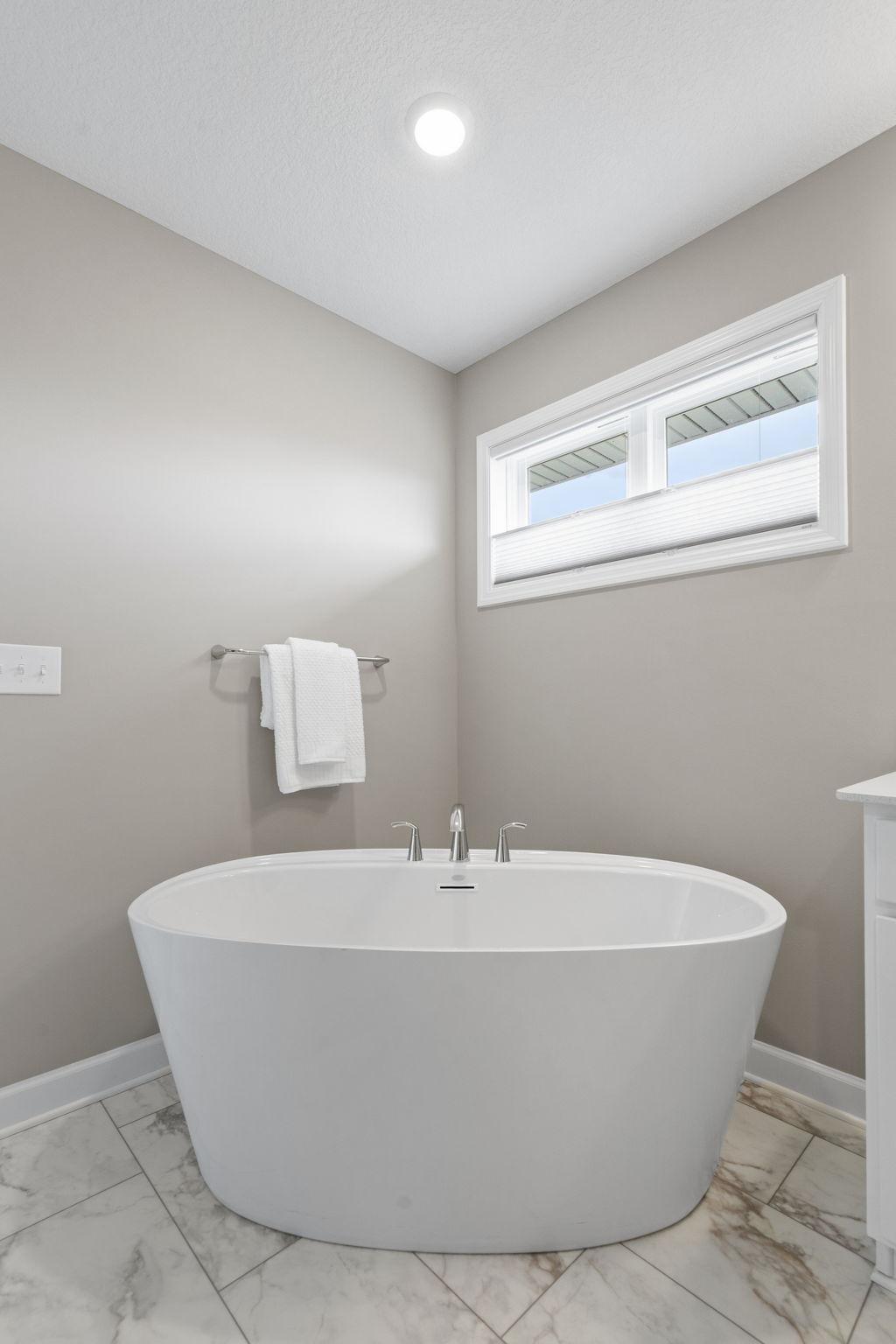 Features oversized soaker tub
