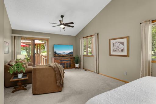 A private sitting wing in the primary suite with walkout access to the deck.