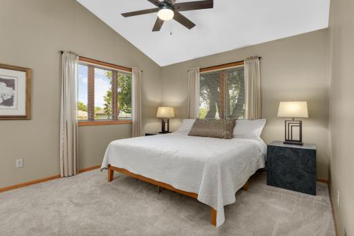 Spacious primary suite, thoughtfully added by the owners, featuring windows that bring the outdoors in.