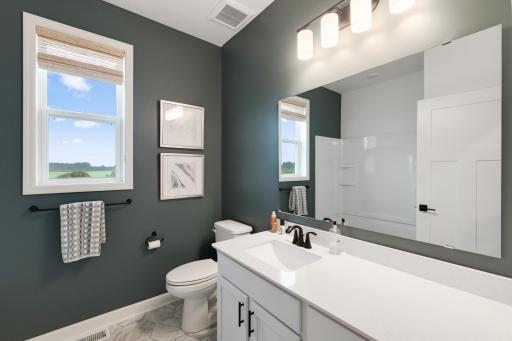 A full-sized bathroom off the foyer is readily accessible to the whole family and daytime guests.