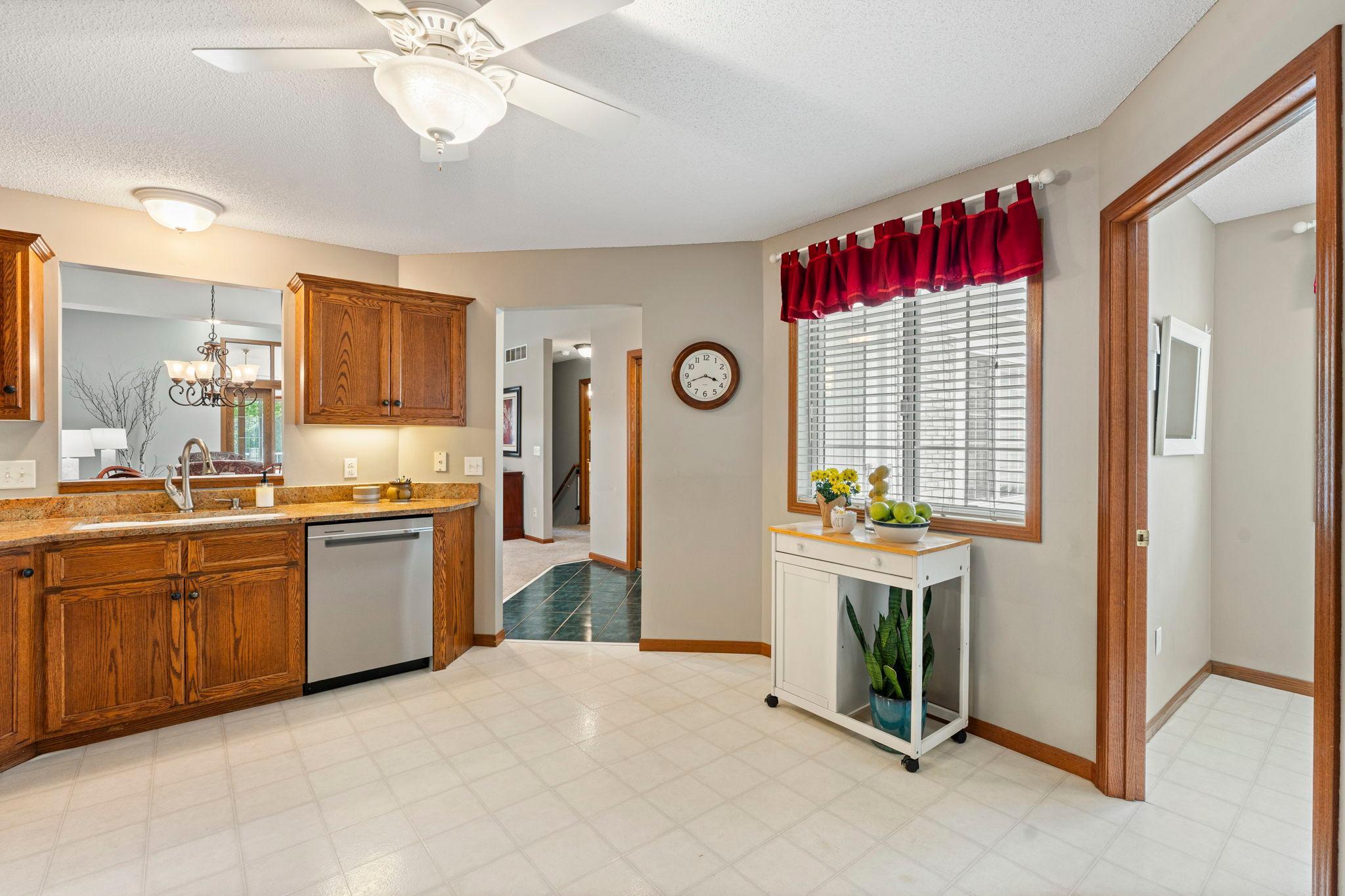 The kitchen is spacious and bright, and has a handy pass-through to the dining room over the sink. The laundry room is on the right.