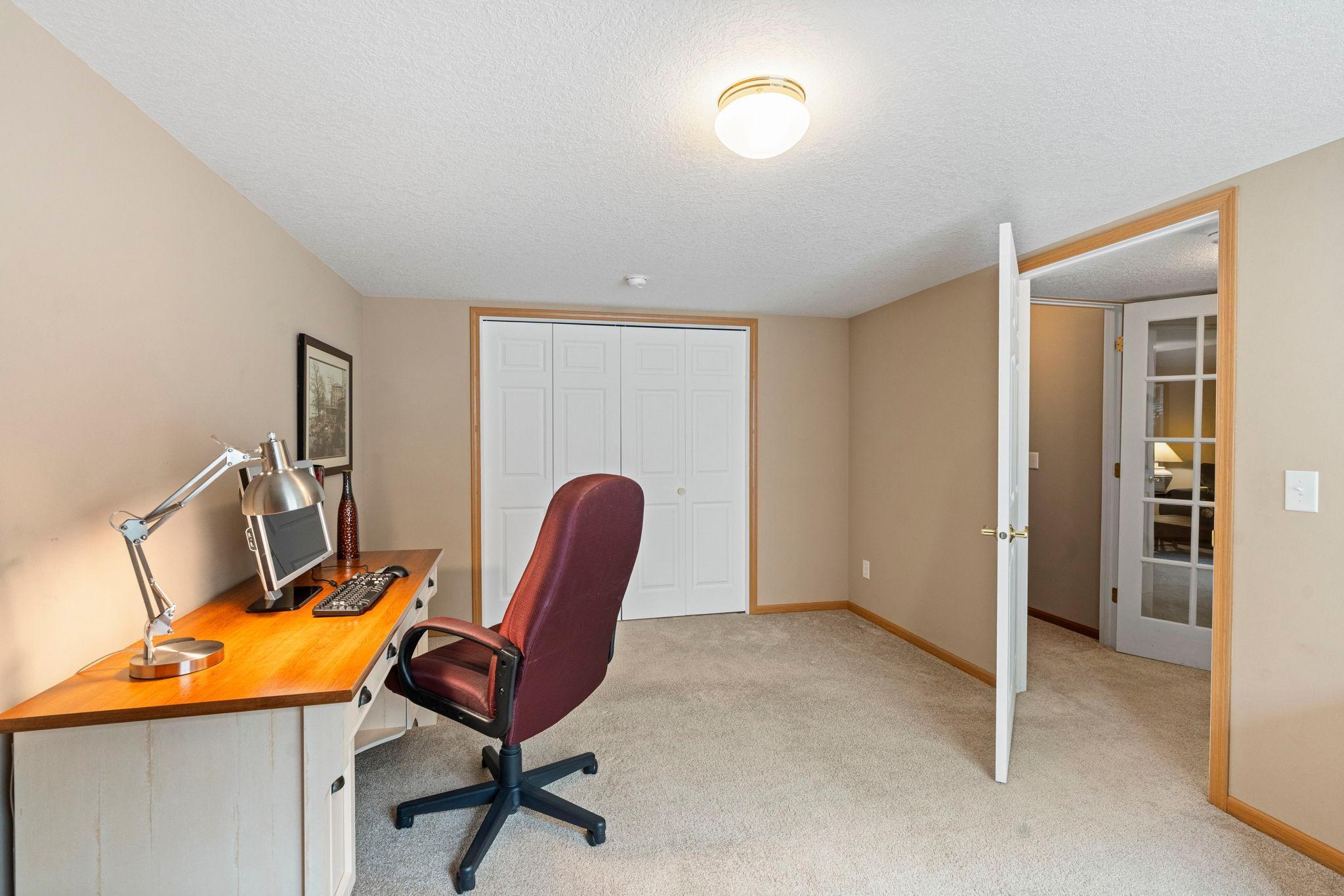 Lower level 3rd bedroom has white paneled doors.