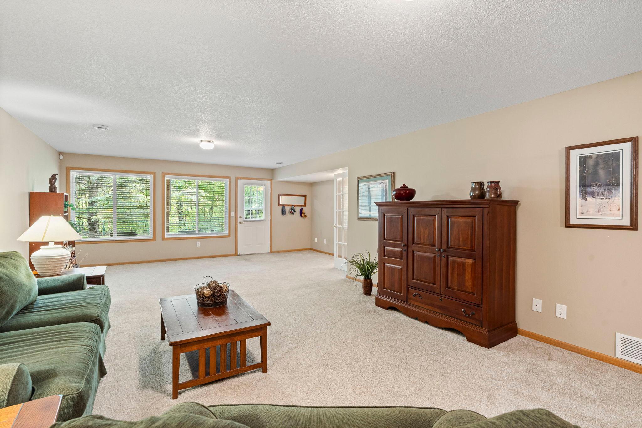Family room walks out to patio, private backyard, view of trees. Staring Lake Park is on the side of the trees with walking paths.