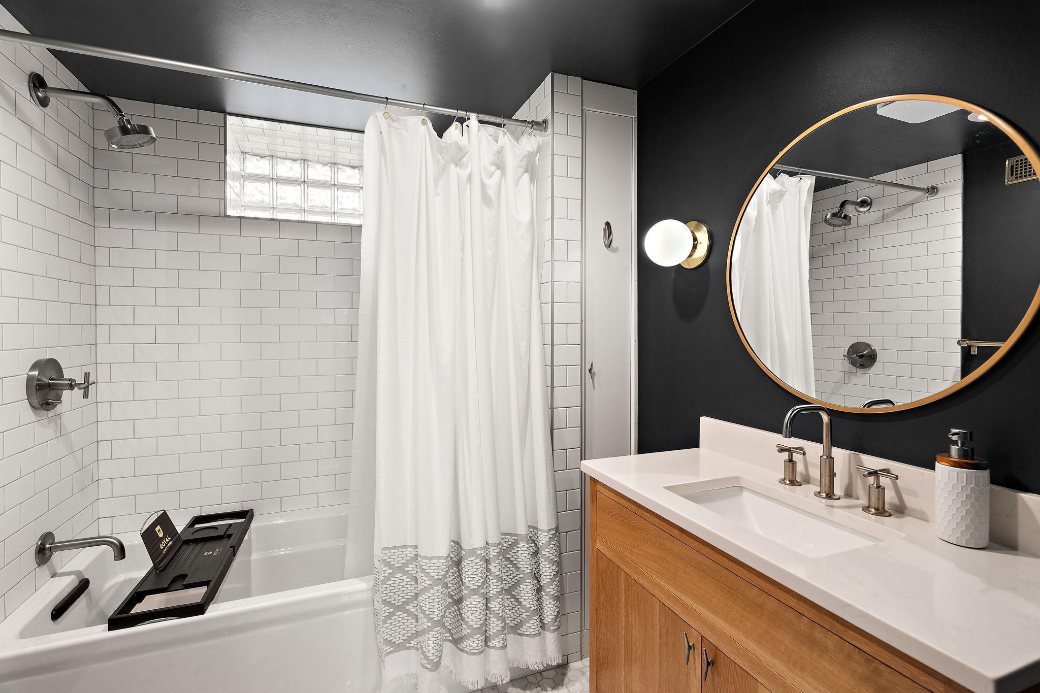 Lower full bathroom with subway tile surround