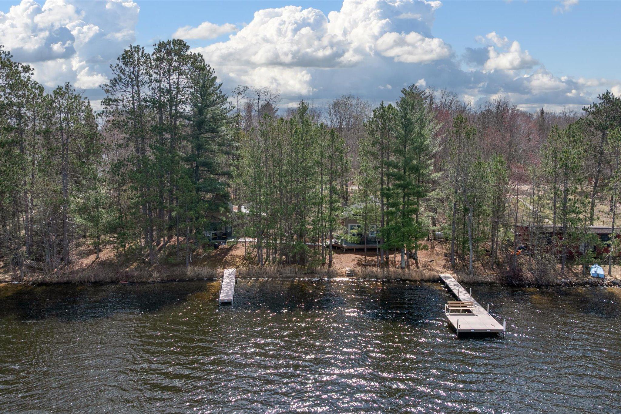 Welcome to the opportunity to own a piece of Vermillion Lake—two cabins, one shared shoreline, captured from the water.