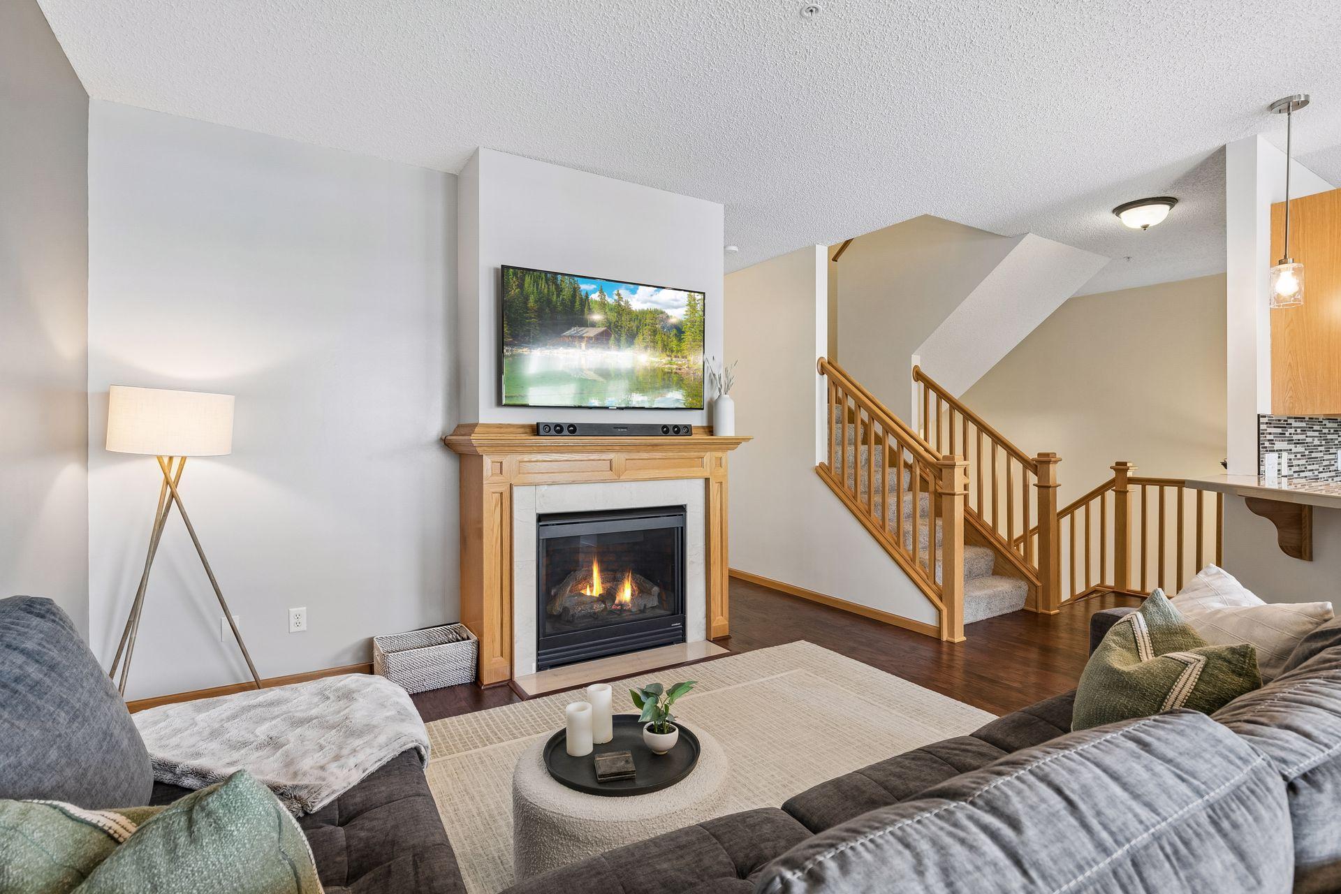 A cozy fireplace frames your living room.