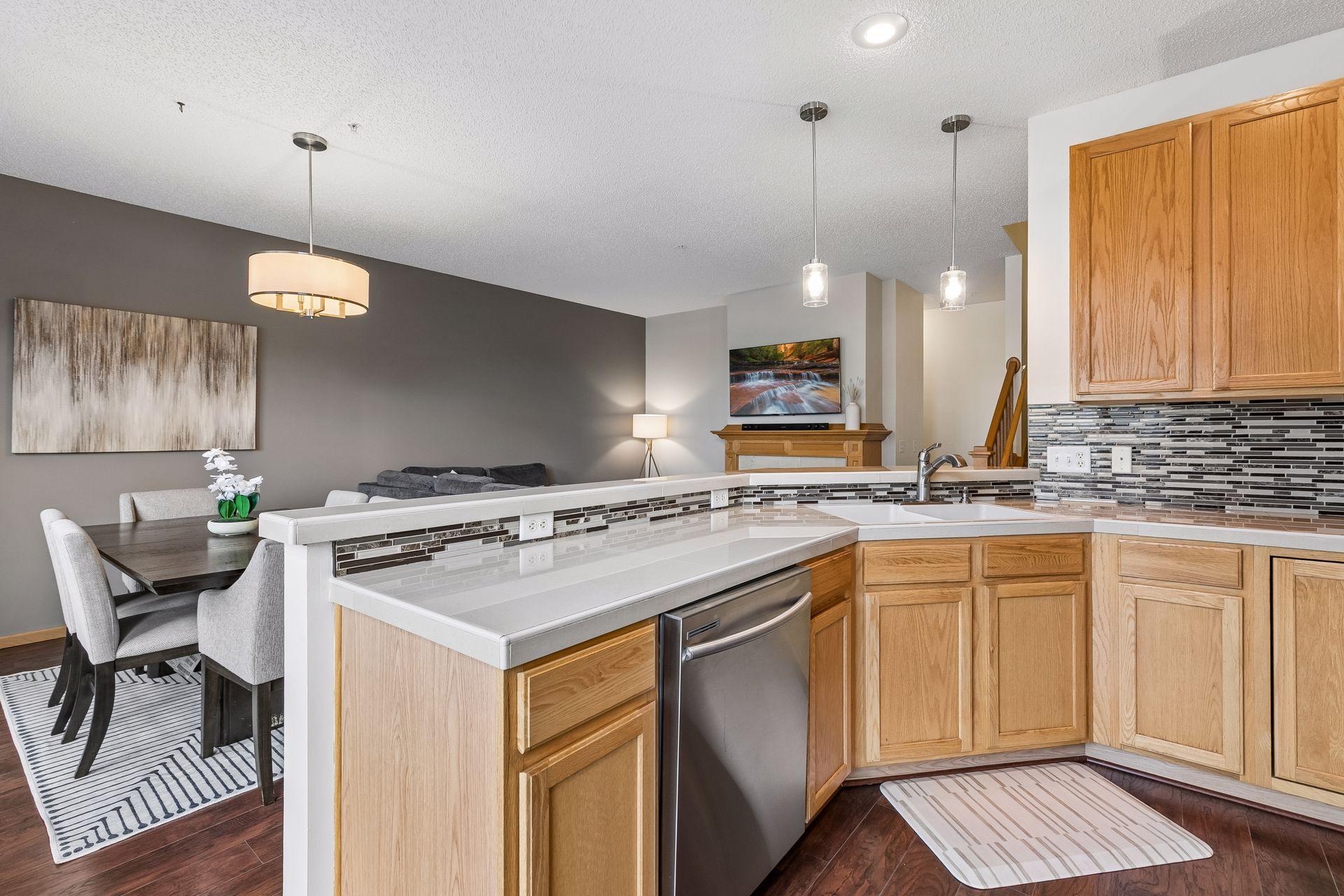 Kitchen overlooks informal dining area and living room.