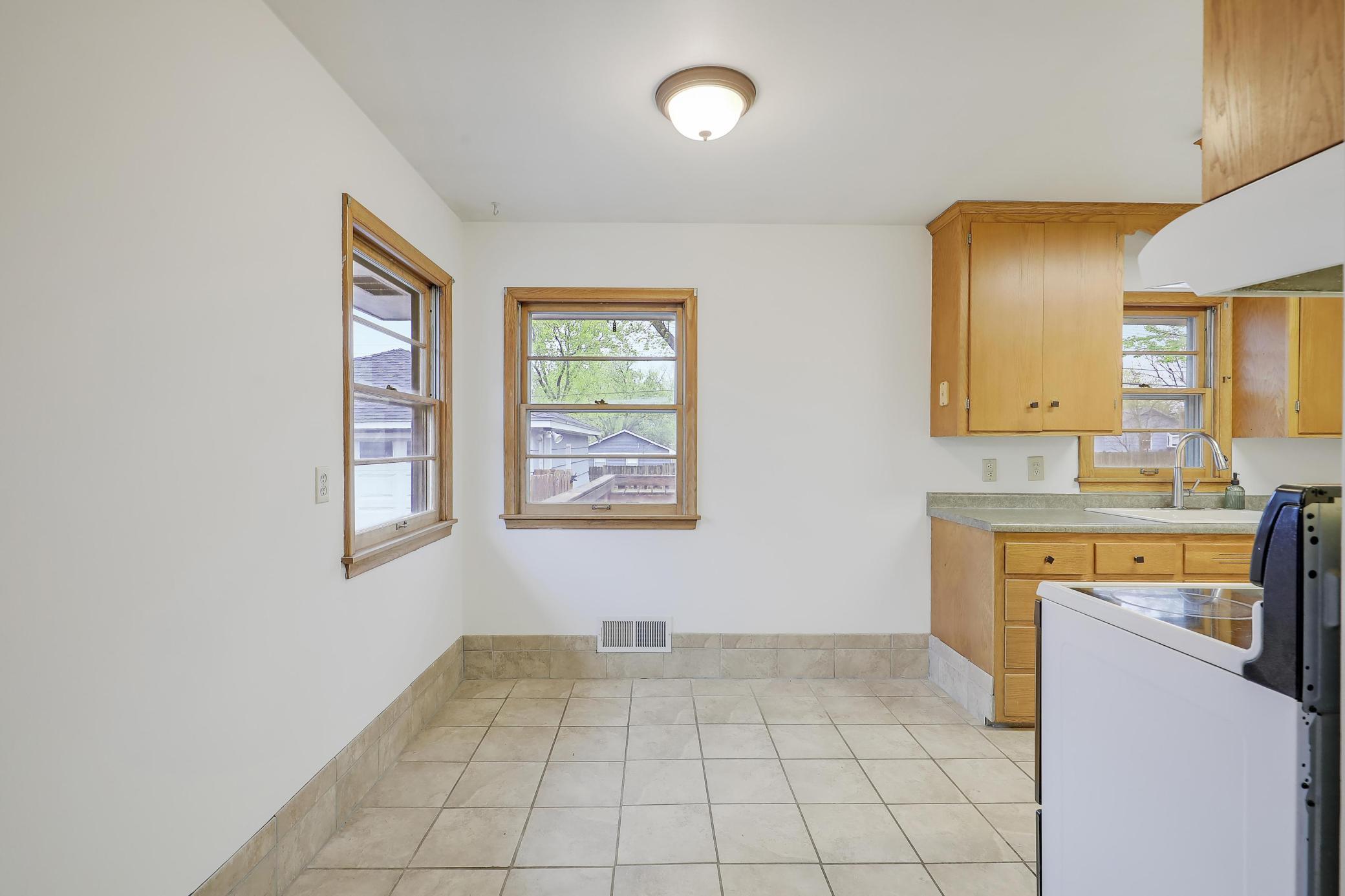 Ceramic flooring, south and west facing windows and darling original cabinetry from the 1950's.