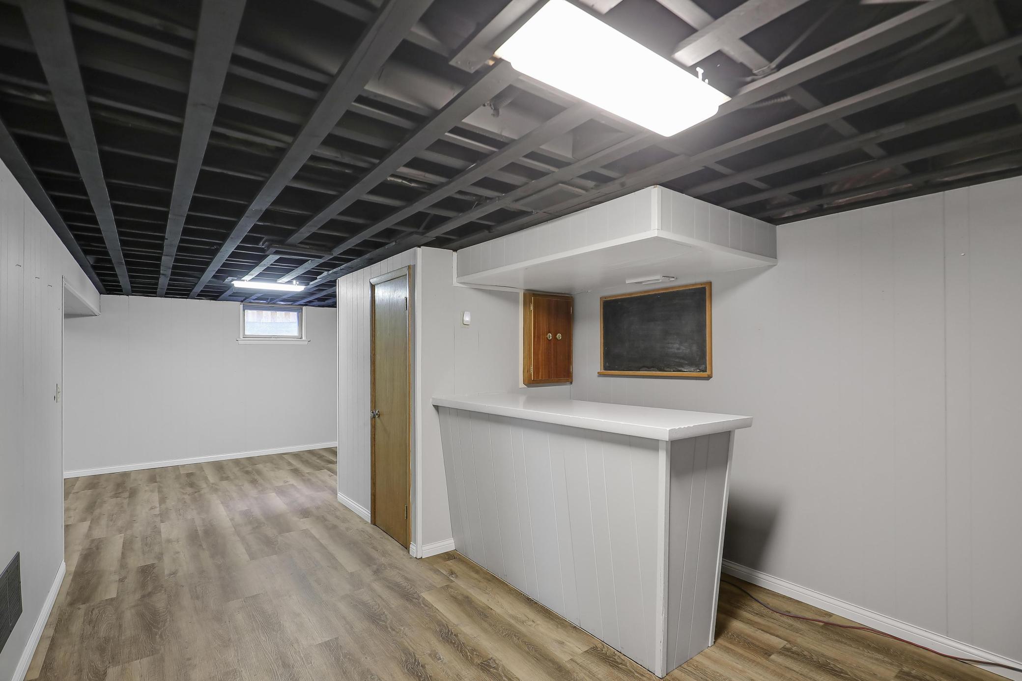 Retro bar and lower level features a 1/2 bathroom behind the door.