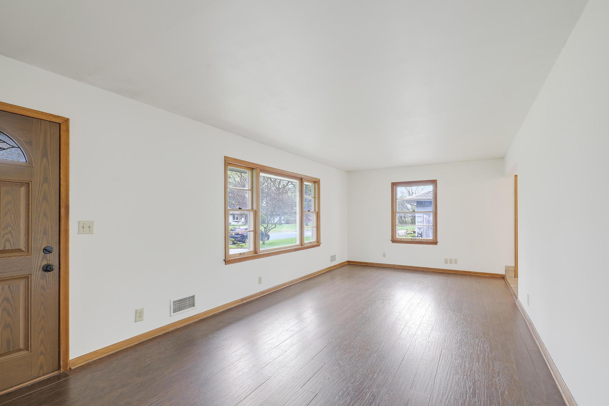 Beautiful flooring and East and South facing windows for wonderful natural light. The main level has been professionally painted so no holes in the wall to patch/paint. Move right in!