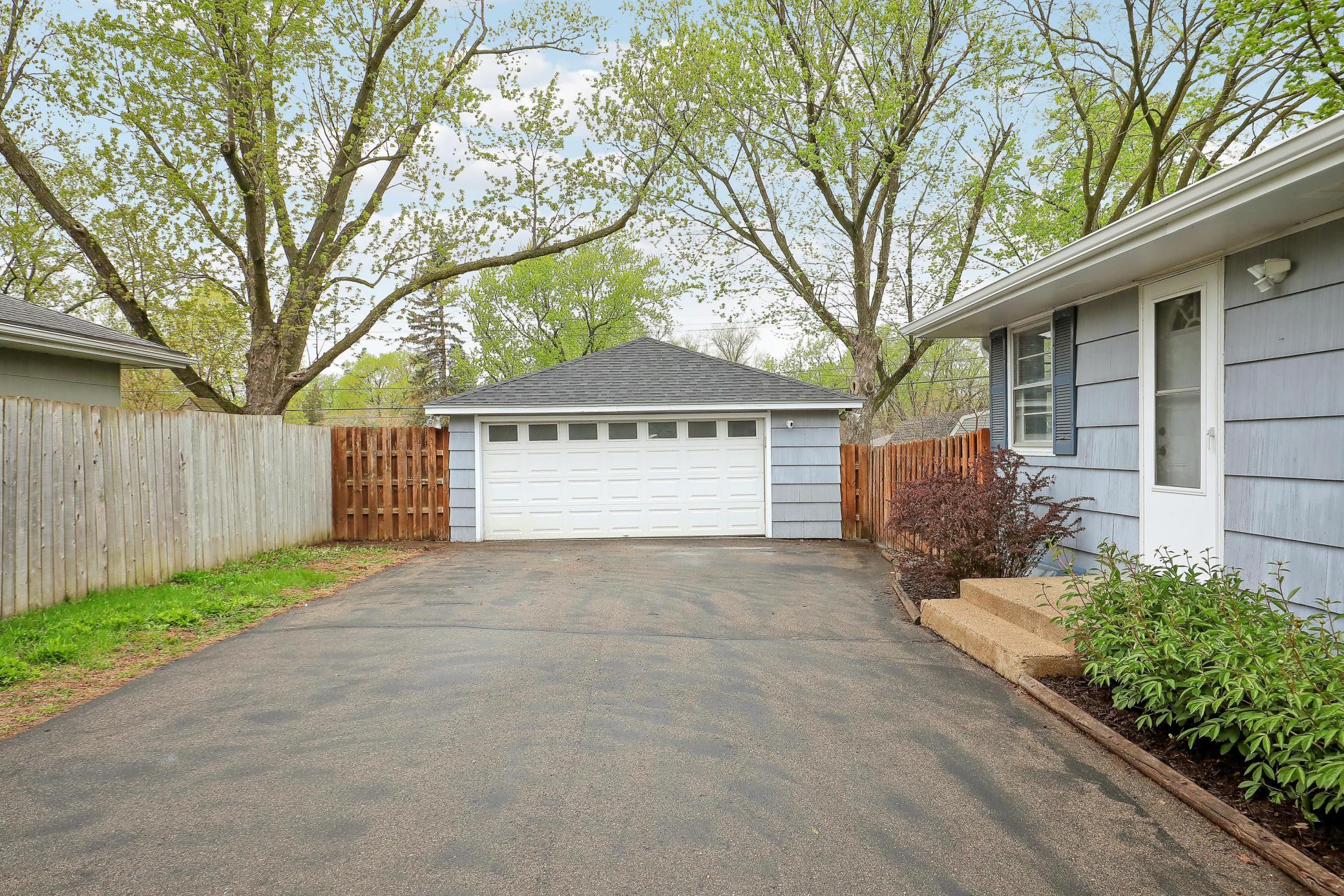 Convenient two car garage. Peony's will be blooming to the right of the side door.