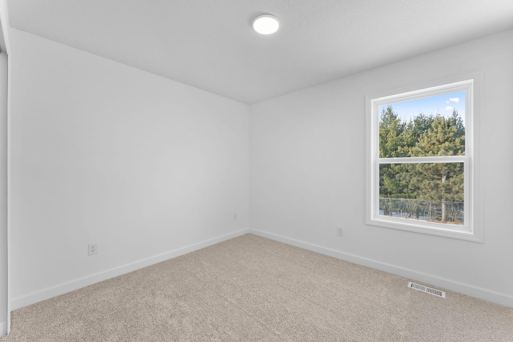 (Photo of a similar home, actual finishes may vary) Three secondary bedrooms are situated upstairs, just down the hall from the owner’s suite.