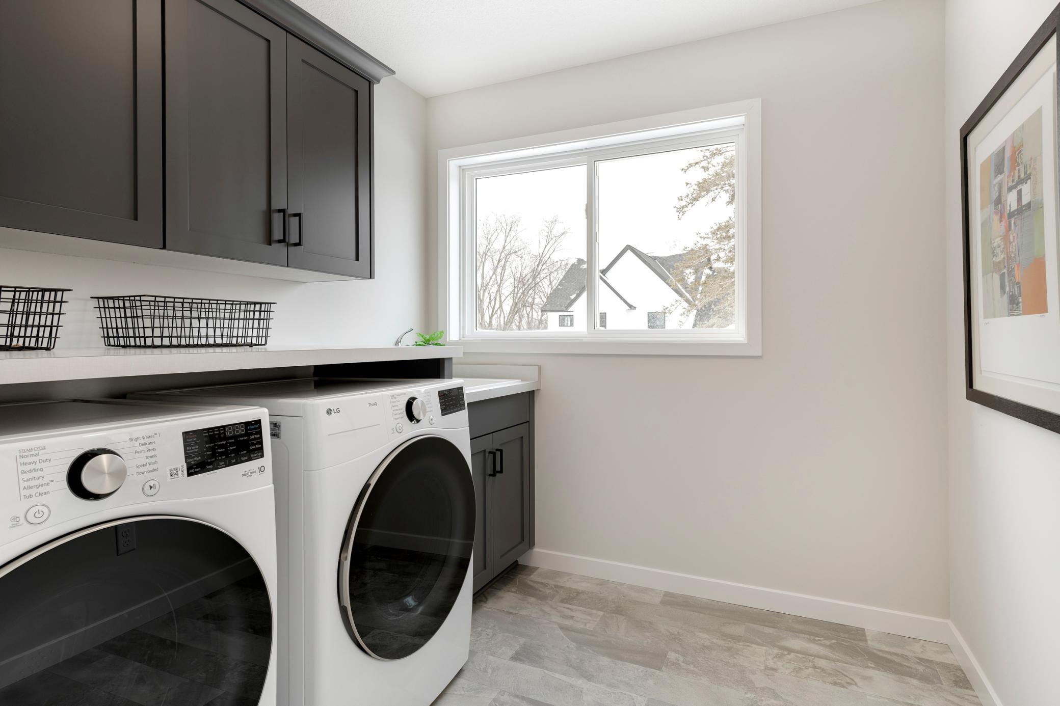 2nd floor laundry room with Laundry sink, window, upper cabinets and W&D included!