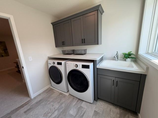 2nd floor laundry room with Laundry sink, window, upper cabinets and W&D included!