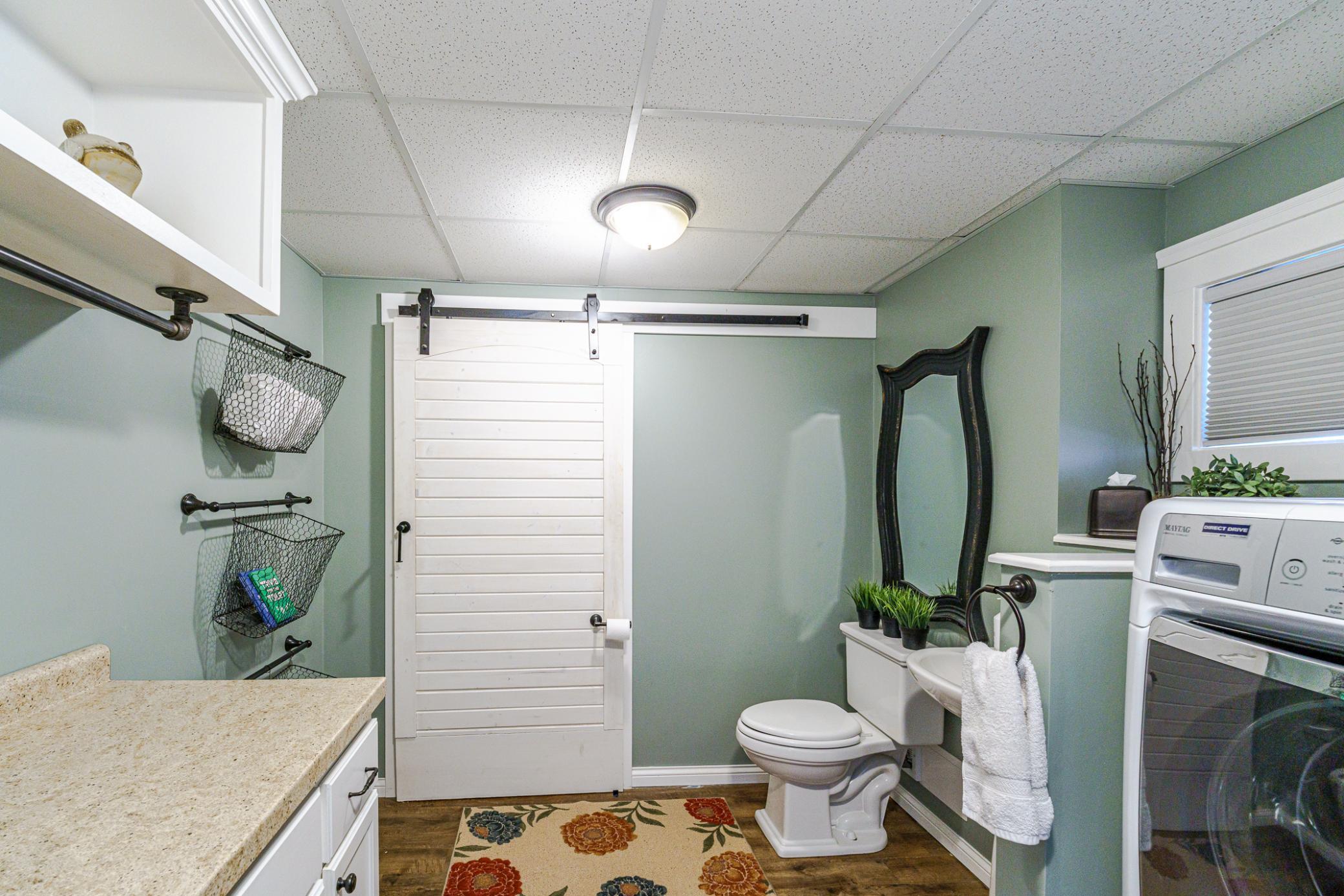 This room includes cabinetry, lots of countertop space, and an industrial-style drip rod.