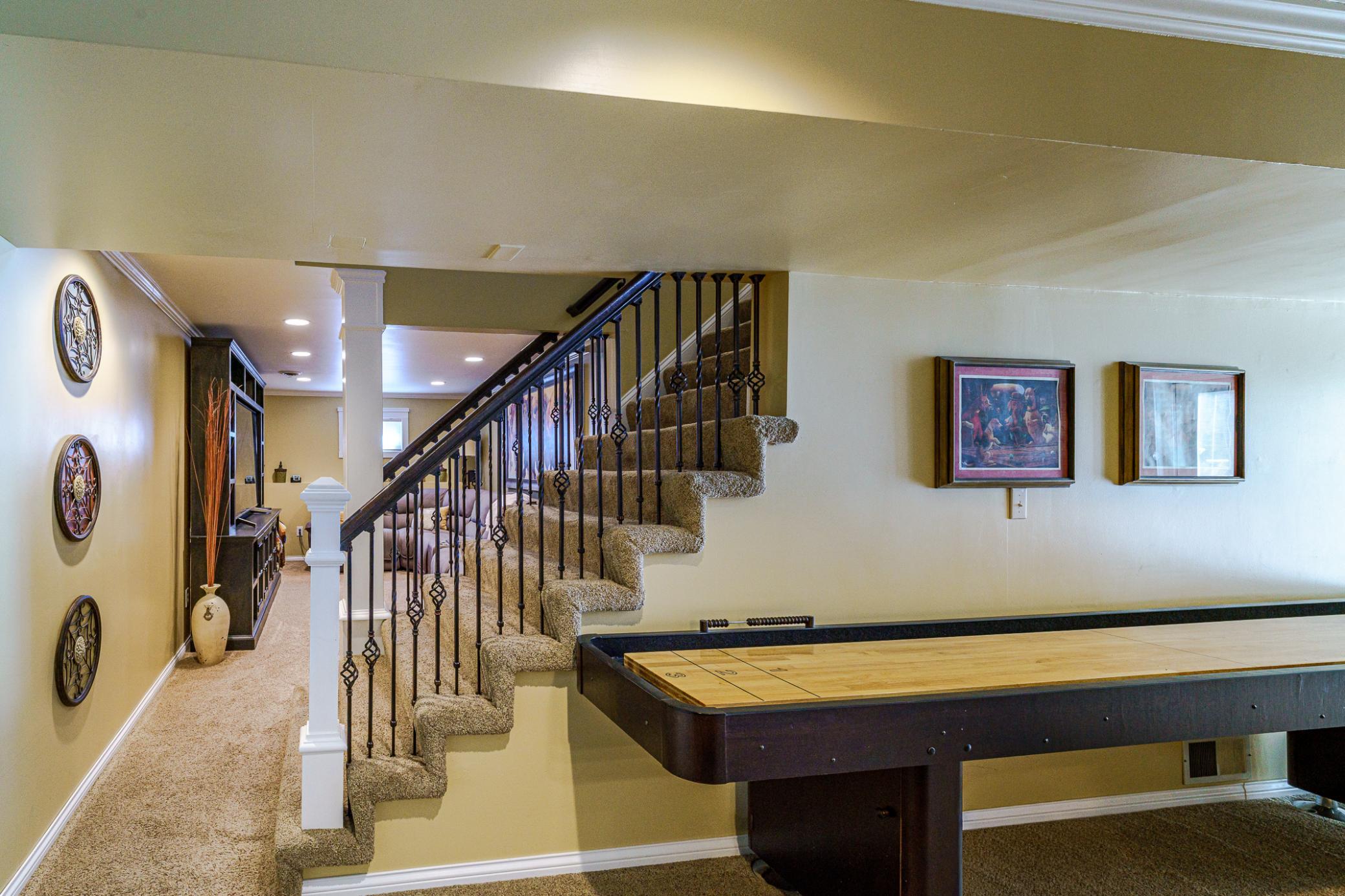 The WALKOUT lower level includes a widened staircase with iron balusters.