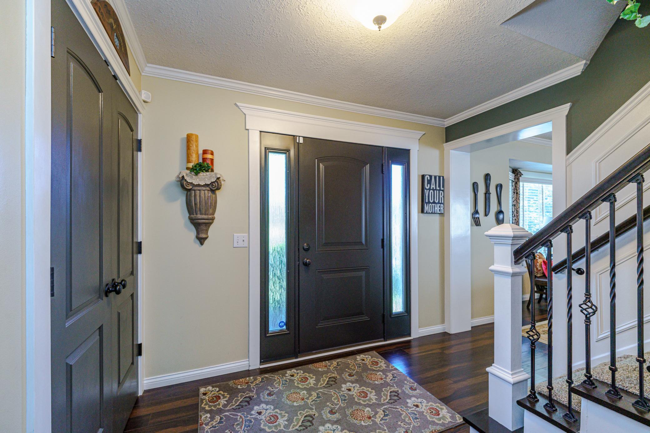 You'll immediately notice the high-style that graces this entire interior, starting from the entry foyer, with an updated front door, interior doors, paneled staircase walls with iron balusters, crown molding and white trim.