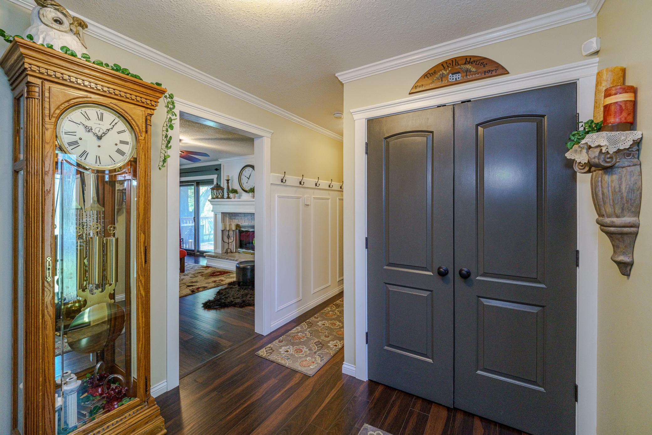 All the interior doors have been replaced with this arched style. The back hall leading to the garage is paneled with hooks for coats.