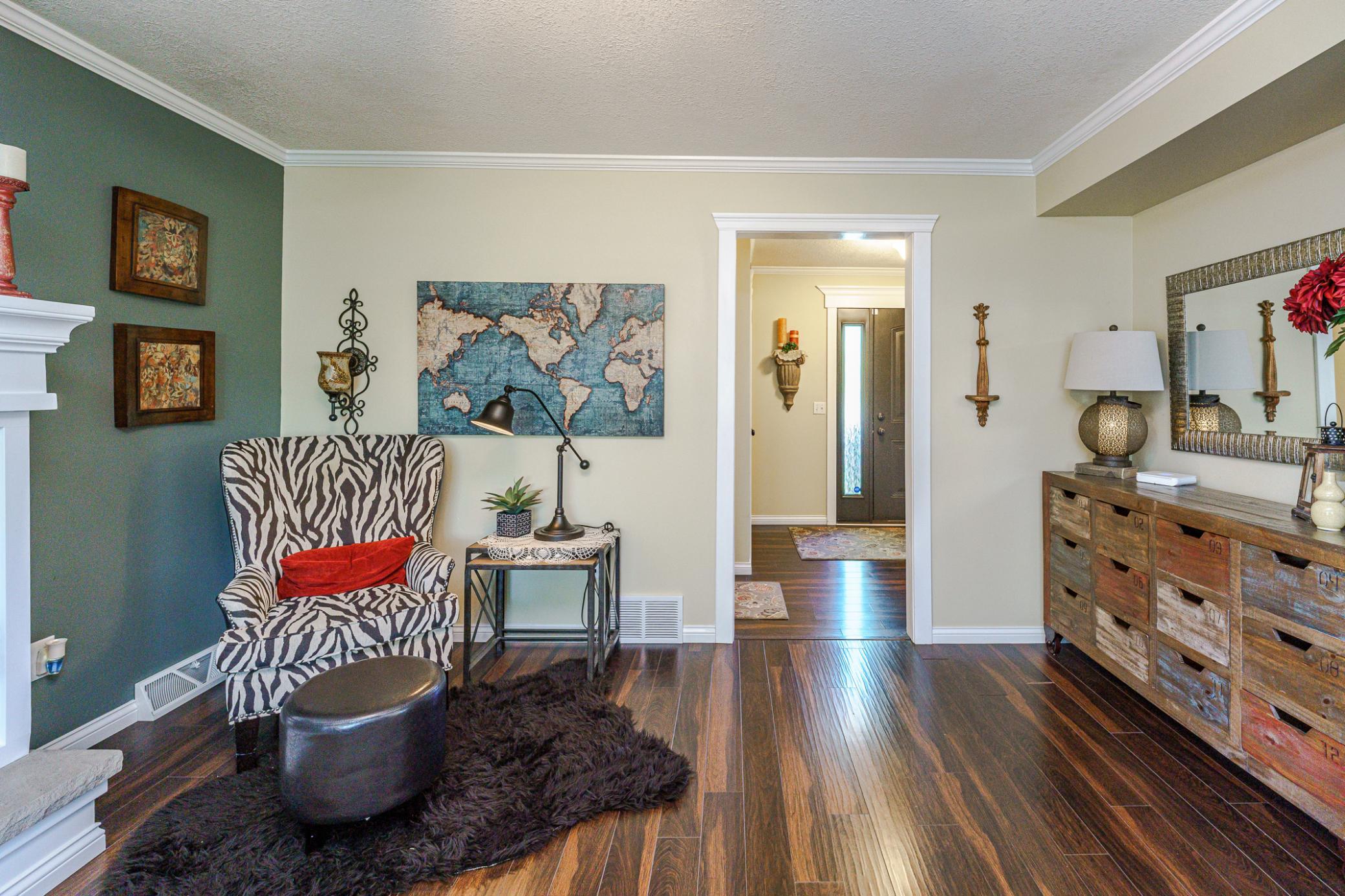 The main floor living room features hardwood flooring and crown molding. The deck can be accessed from this room.