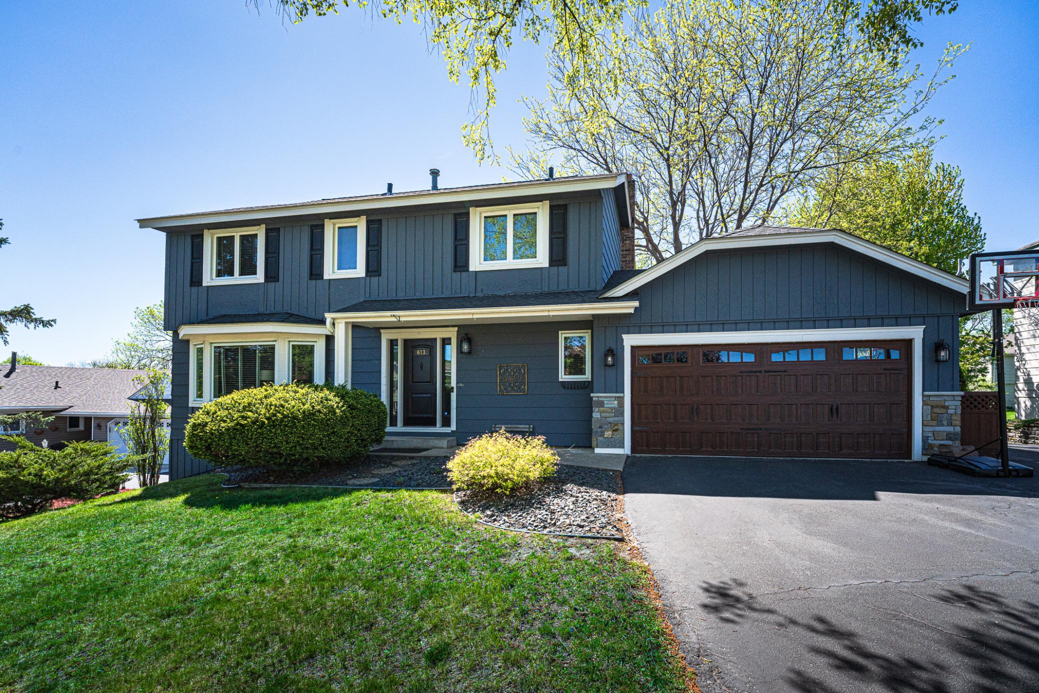 The exterior is an updated color with a refreshed carriage style garage door.