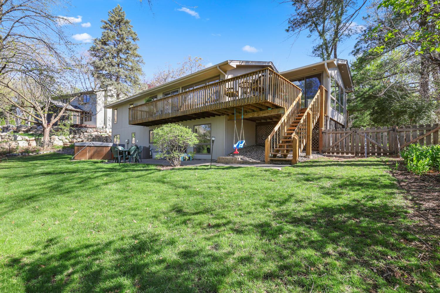 Huge deck with steps to lower patio area.