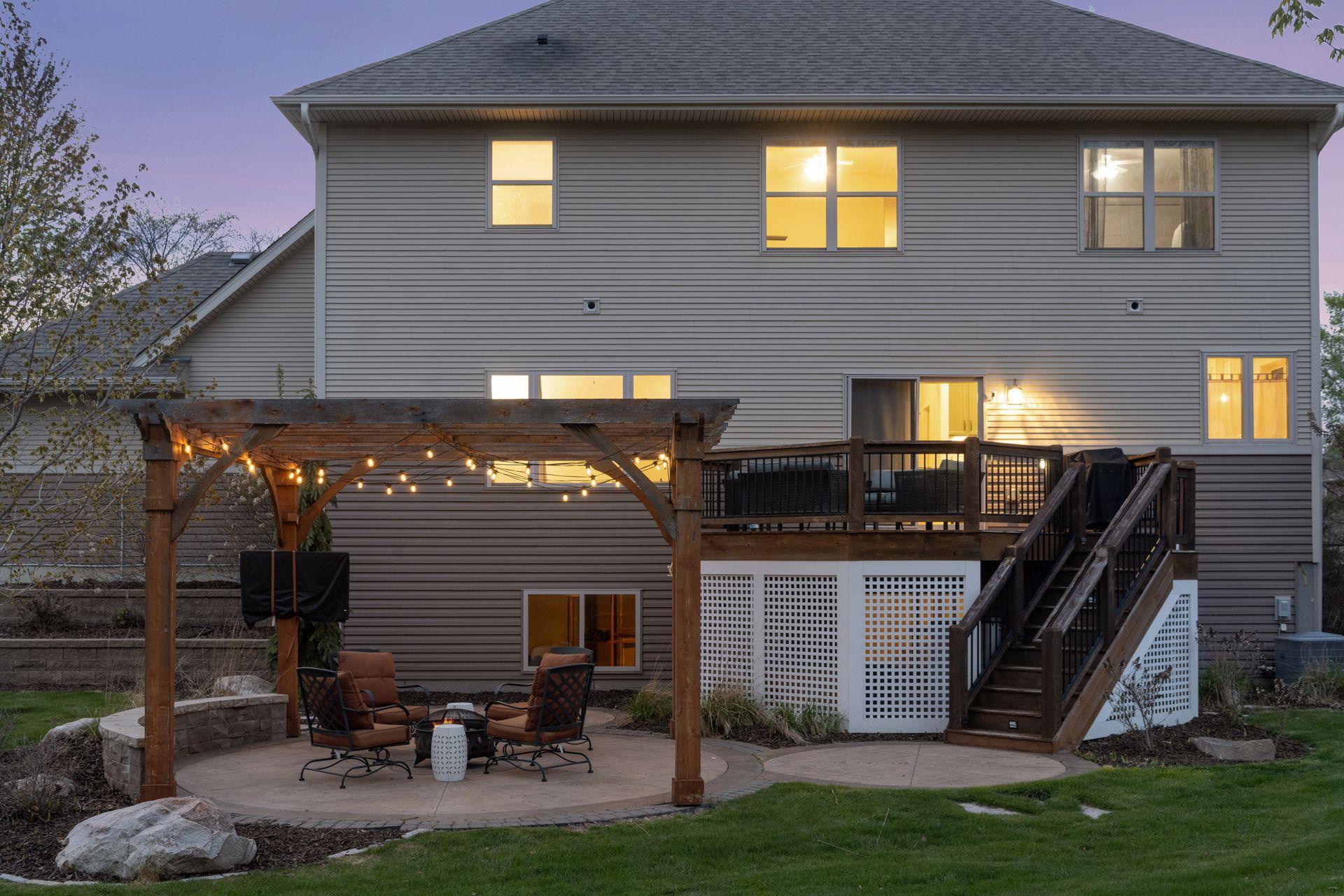 The backyard has multiple seating areas to enjoy the outdoors.