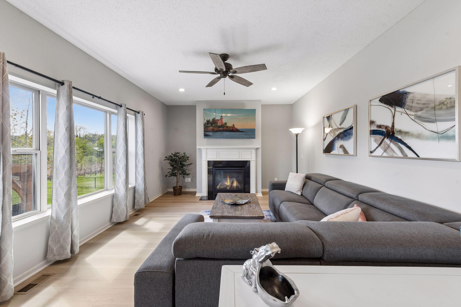 This bright room has a wall of windows and recessed lighting.