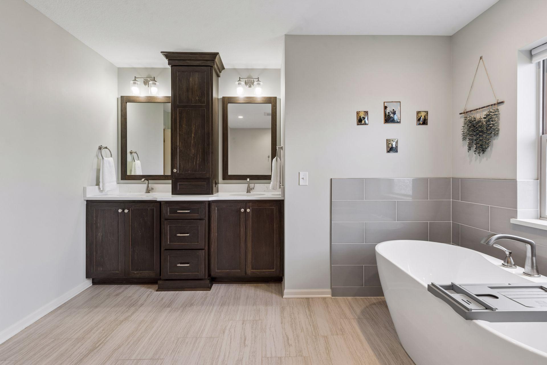 The bathroom has a dual sink vanity with a large amount of storage.