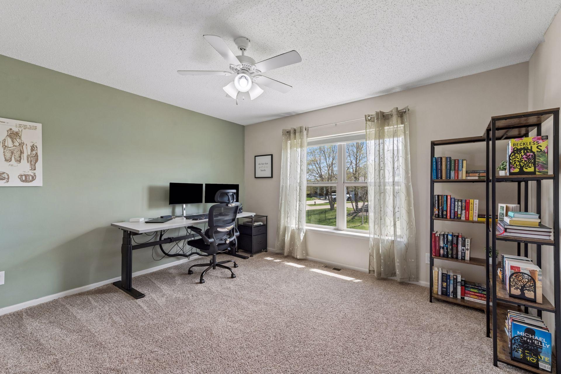 The sellers are using the third bedroom as an additional office. This room also has a ceiling fan and reach-in closet.