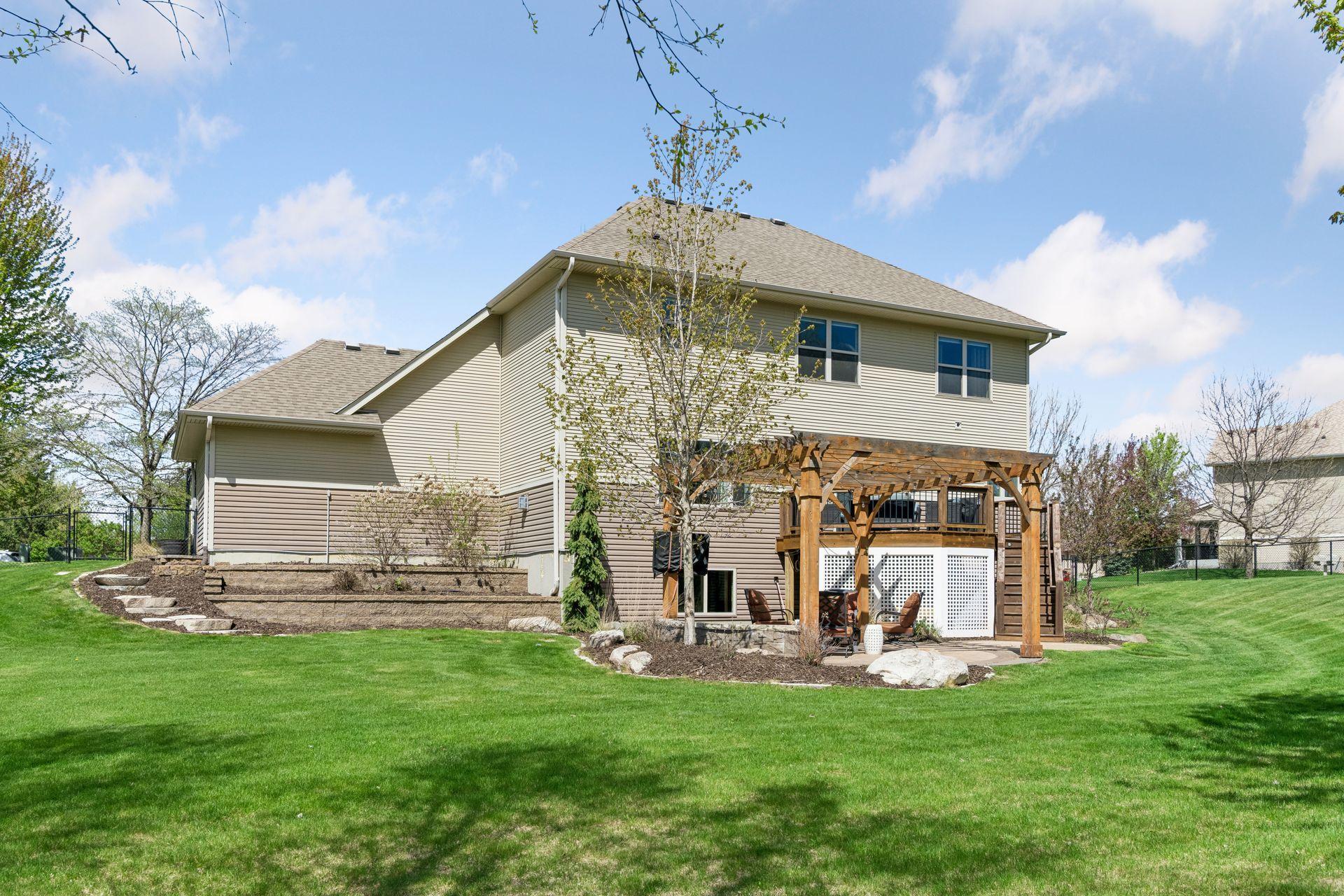 Behind the garage are stone retaining walls and steps to the backyard.