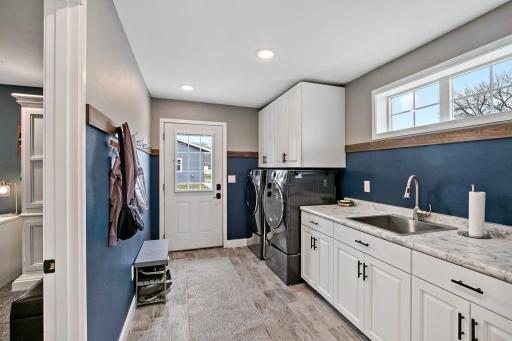 Big back entry mud room and room for shoes by the back door.