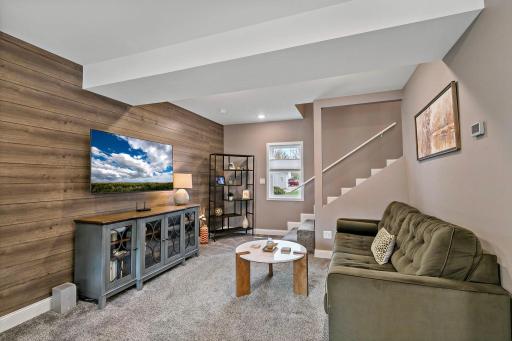 Main level family room with new carpet, fresh paint, lighting and more!