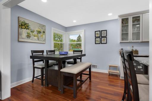 The informal dining room has space for six, with room at the breakfast bar for two more!