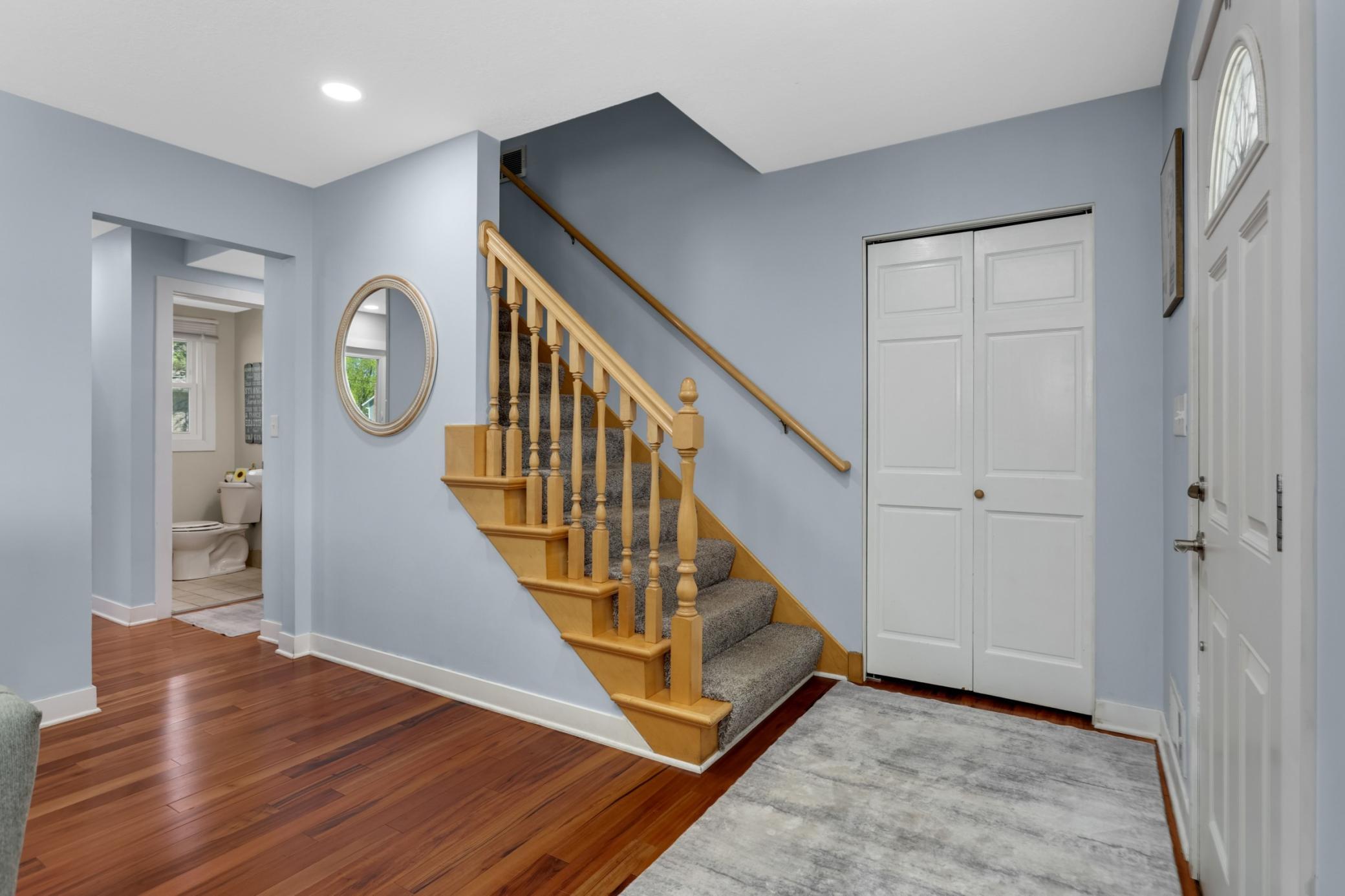 The lovely banister helps keep the spacious feel to the main floor.